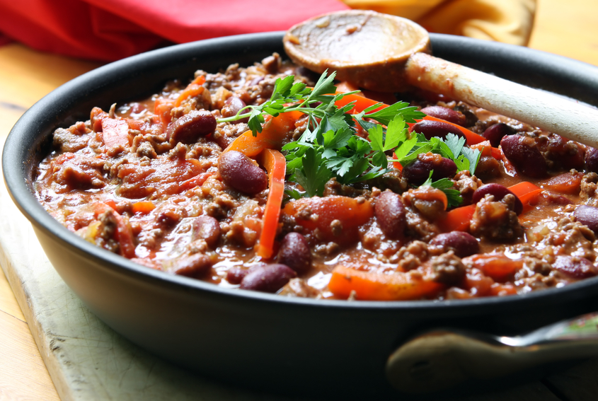 A pan of chilli, ready to serve.  Soft focus, shallow depth of field.